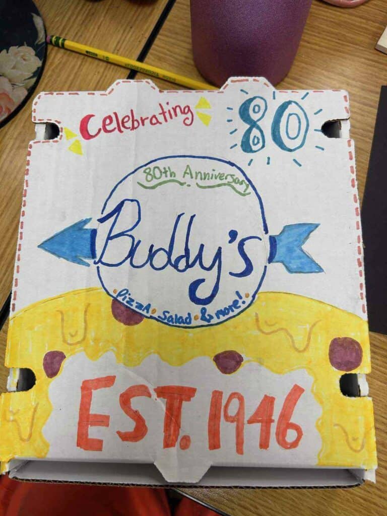 Buddy's Pizza, 80th anniversary celebration sign with colorful hand-drawn design.