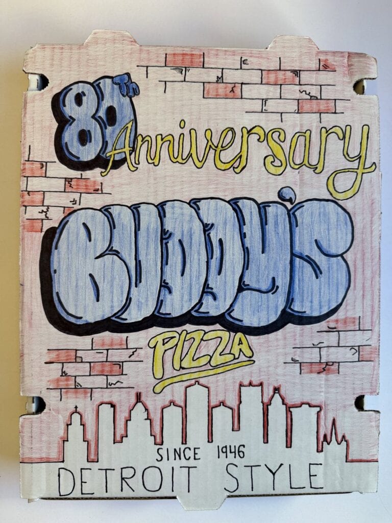 Hand-painted sign celebrating Buddy’s Pizza 81st anniversary in Detroit.